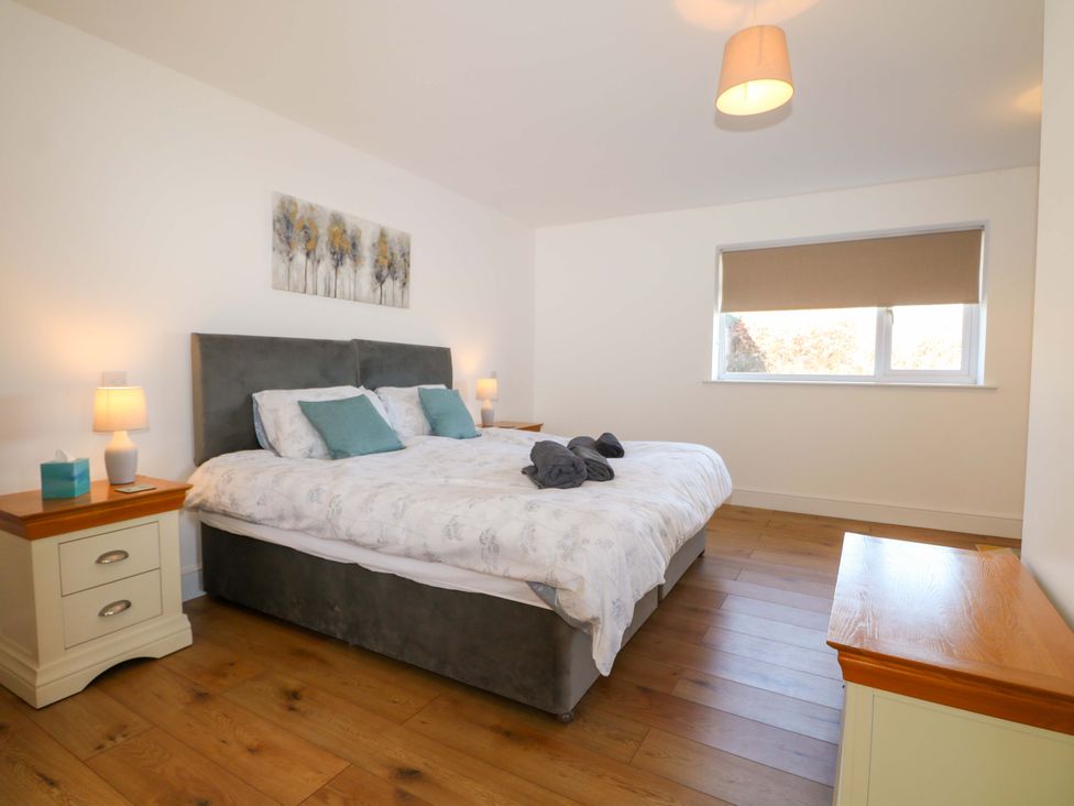 A bedroom with a bed and nightstands at Blue Bell Cottage near Lenham