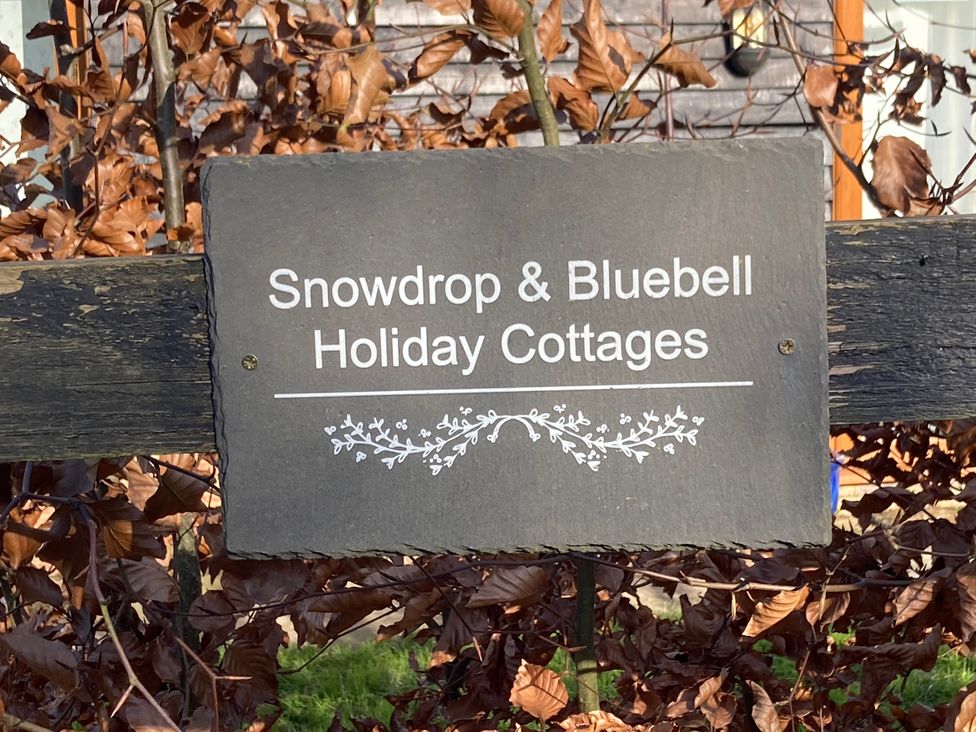 A sign for Snowdrop & Bluebell Holiday Cottages