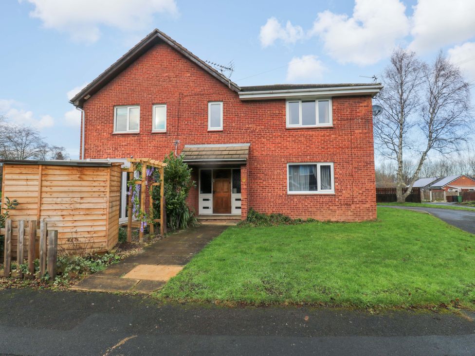 A house with a front door and windows with grass and a pathway at Cosy Nook Leeds