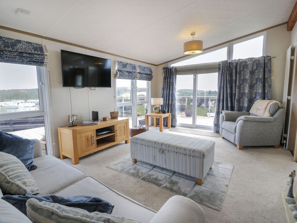 A living room with furniture and a television at 1, Fisherman’s hill