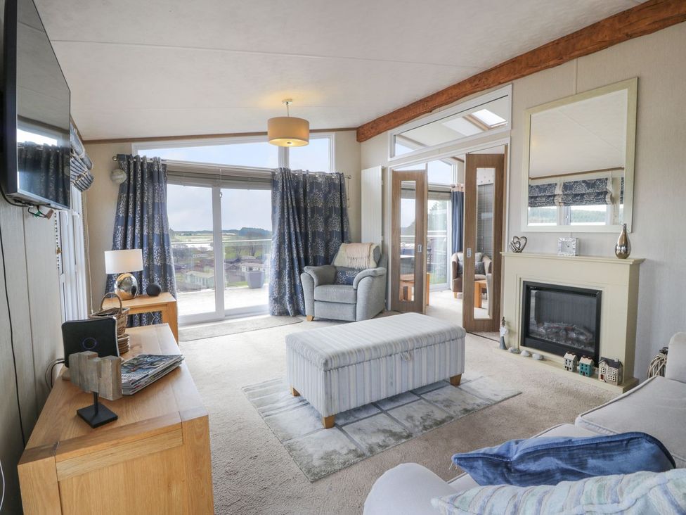 A living room with a sofa and armchair at 1, Fisherman’s hill 