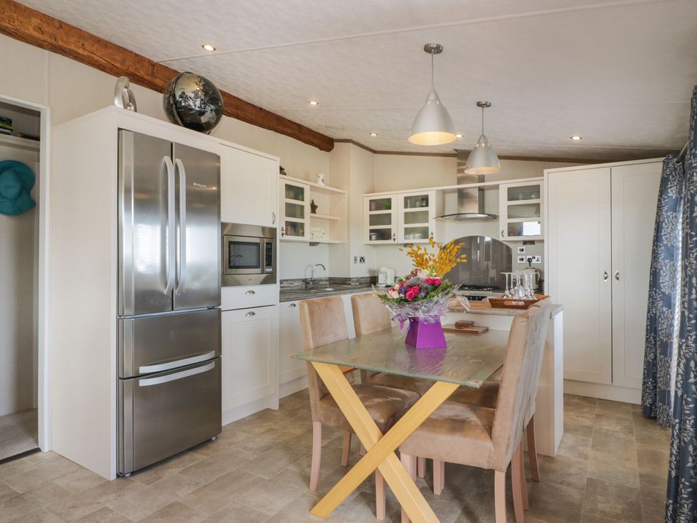 A kitchen with a refrigerator and stove at 1, Fisherman’s hill 