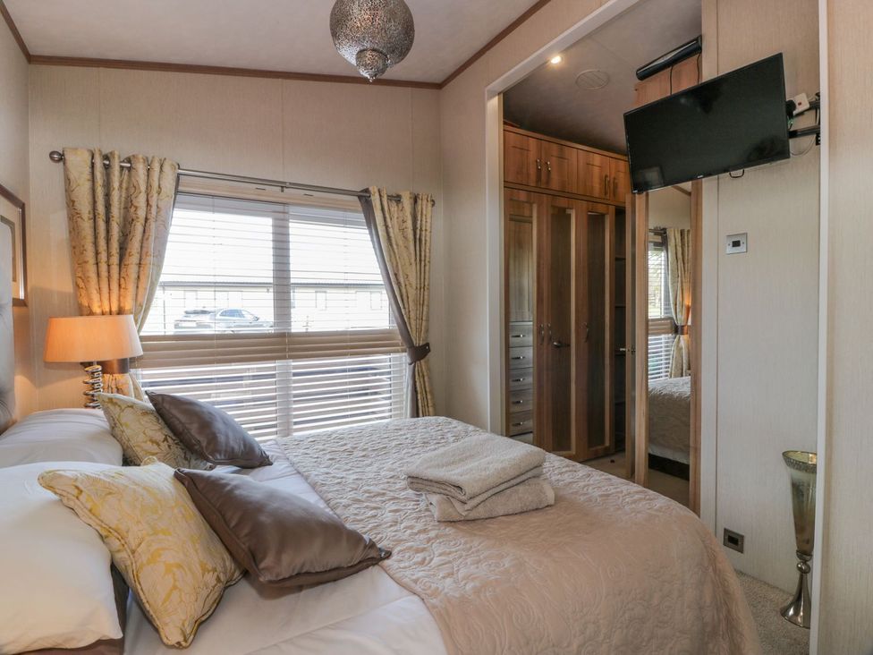 A bedroom with a bed and television at 1, Fisherman’s hill