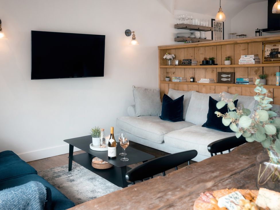 A living room with a sofa and television at 28 Piazza in St Ives