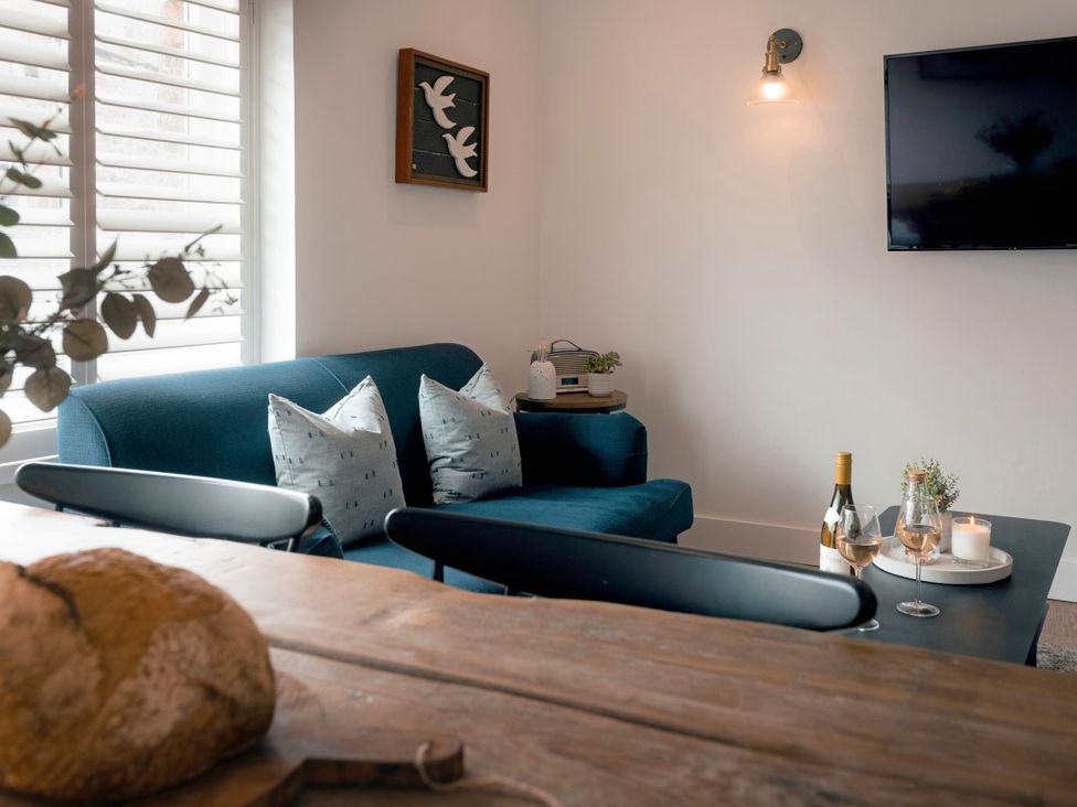 A living room with a sofa and television at 28 Piazza in St Ives