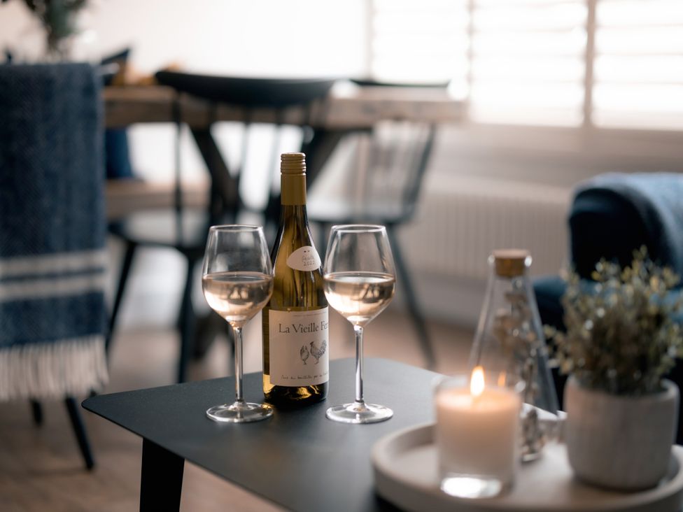 A living room with wine glasses and a candle at 28 Piazza in St Ives