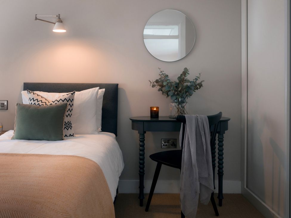 A bedroom with a bed and side table at 28 Piazza St Ives