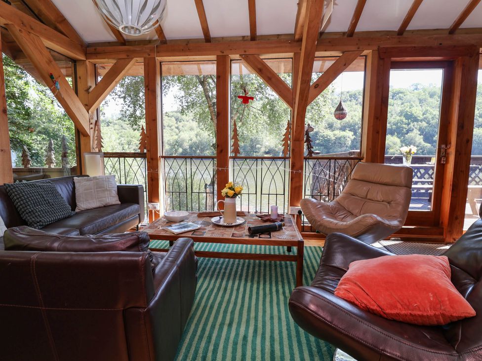 A living room with sofas and a coffee table at The Boat House in Rudyard Lake