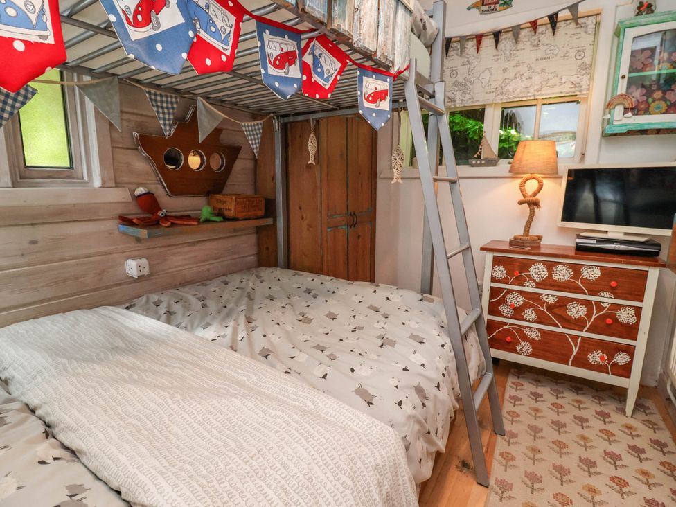 A bedroom with a bunk bed and a TV at The Boat House Rudyard Lake
