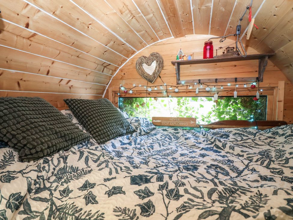 A bedroom with a bed and shelf at The Boat House in Rudyard Lake