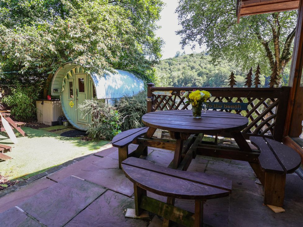 An outdoor seating area with a table and a flower vase at The Boat House in Rudyard Lake