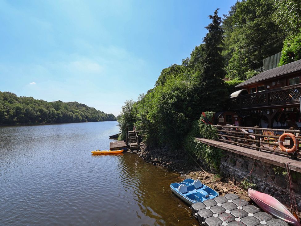 A river with a kayak and boats at The Boat House in Rudyard Lake
