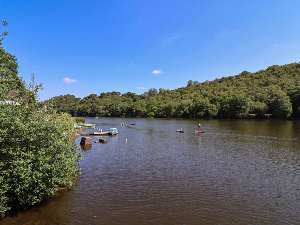A river with paddleboards and kayaks at The Boat House in Rudyard Lake