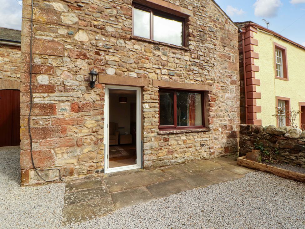 An exterior view of a stone building with a door and window at The Barn in Warcop