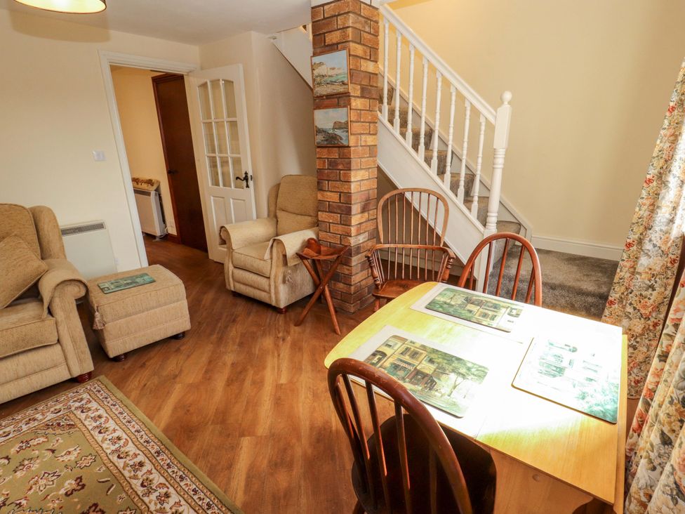 A living room with a sofa and dining table at The Barn in Warcop