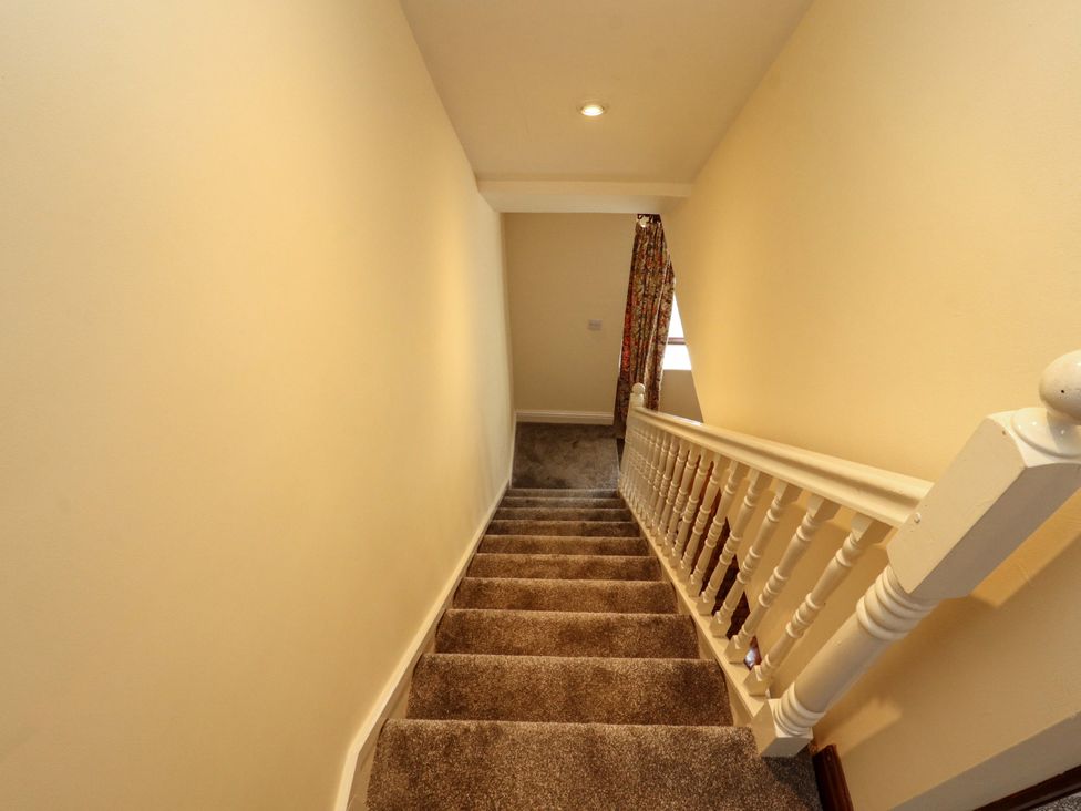 A staircase with carpet and a curtain at The Barn in Warcop