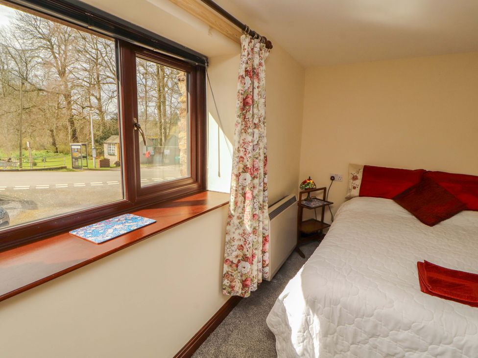 A bedroom with a window and a bed at The Barn in Warcop