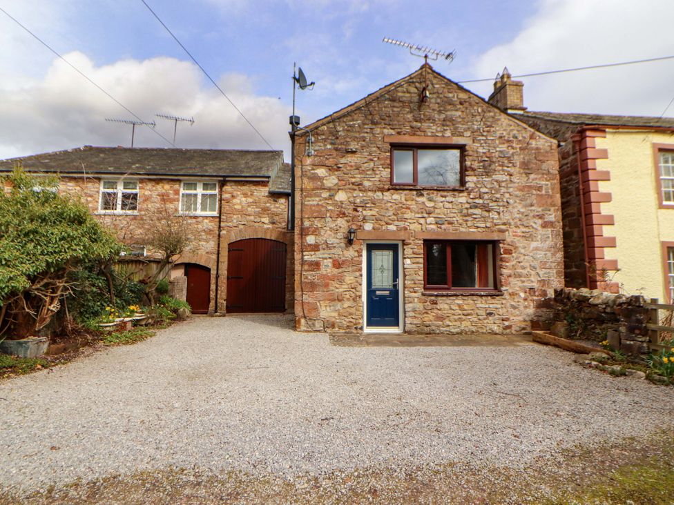A house with gravel driveway and stone exterior at The Barn in Warcop