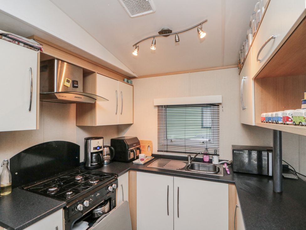 A kitchen with cabinets and appliances at 37 Redcar