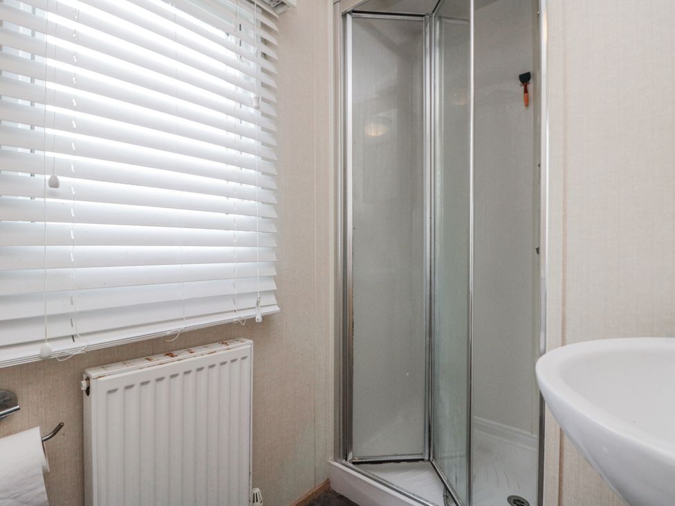 A bathroom with a shower and sink at 37 Redcar