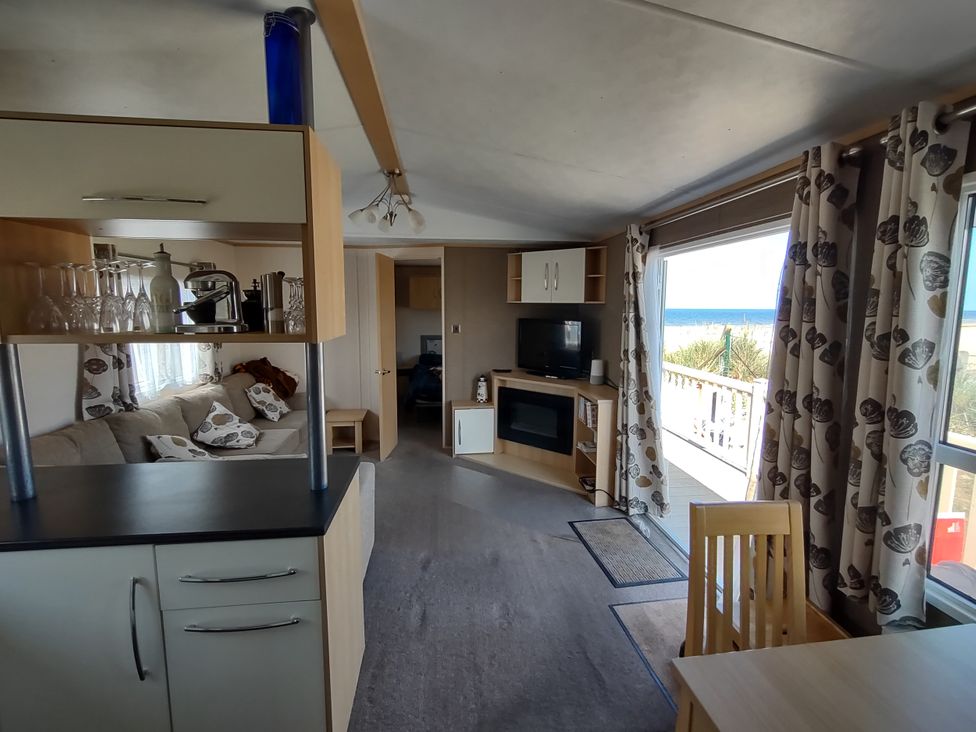 A living room with a sofa and television at Sands Retreat in Redcar