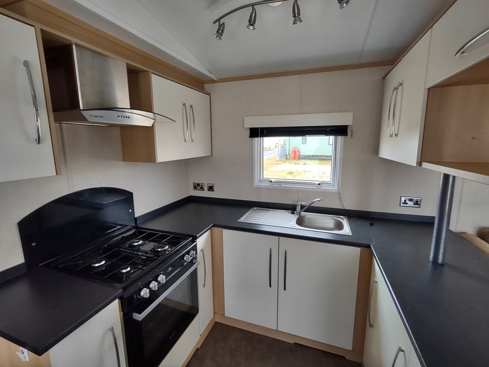 A kitchen with a sink and cooker at Sands Retreat in Redcar