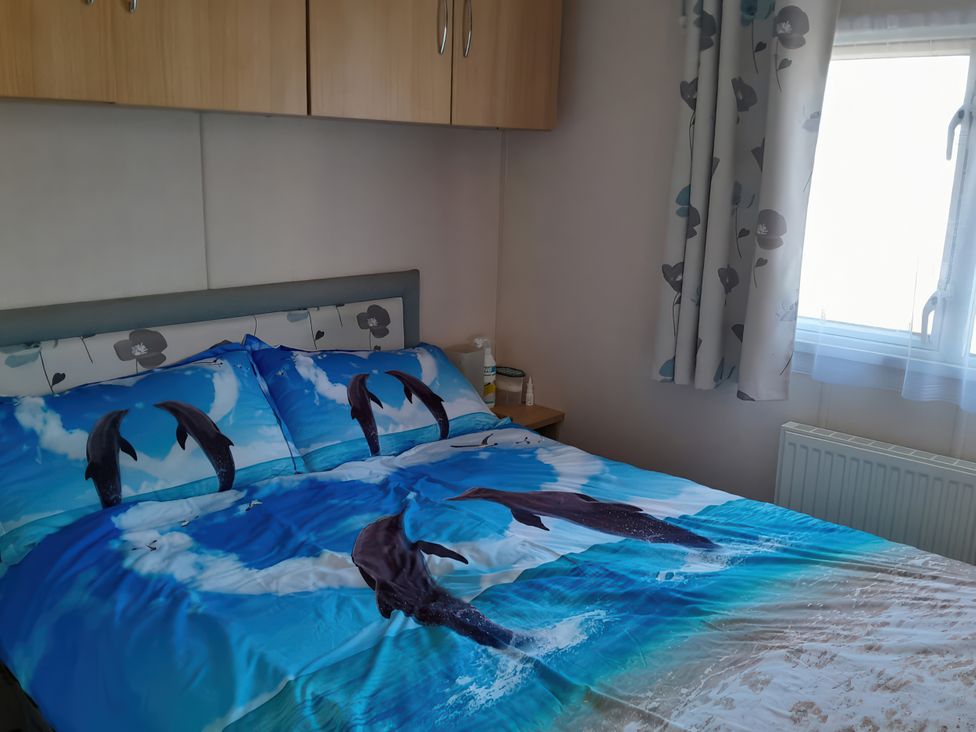 A bedroom with a bed and a bedside table at Sands Retreat in Redcar