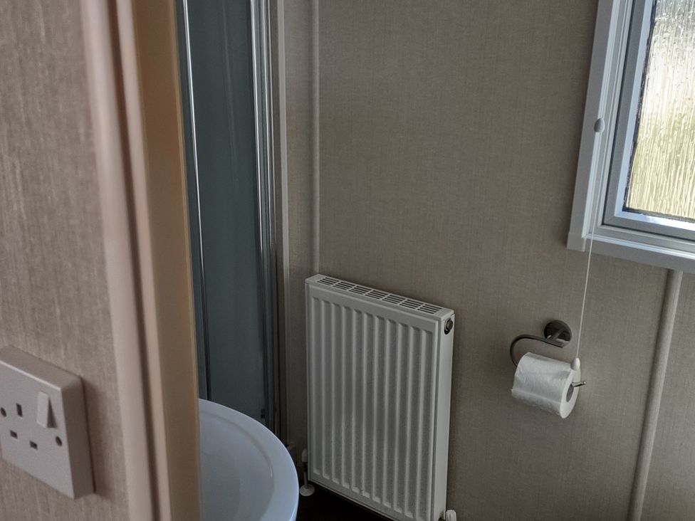A bathroom with a sink and shower at Sands Retreat in Redcar