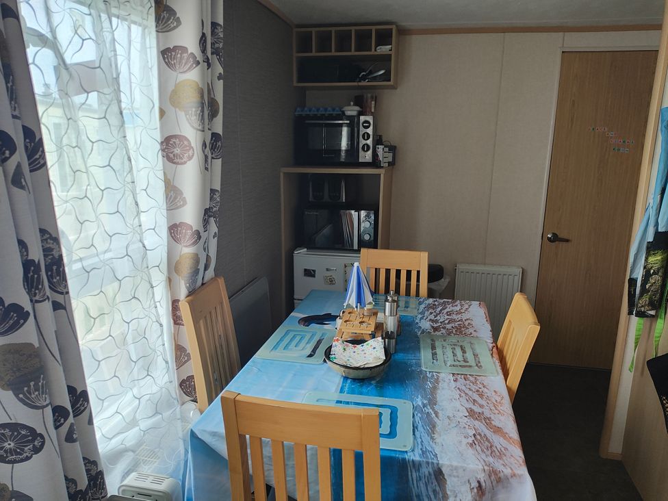 A dining room with a table and chairs at Sands Retreat in Redcar