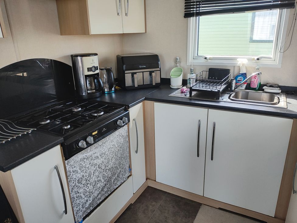 A kitchen with a stove and appliances at Sands Retreat in Redcar