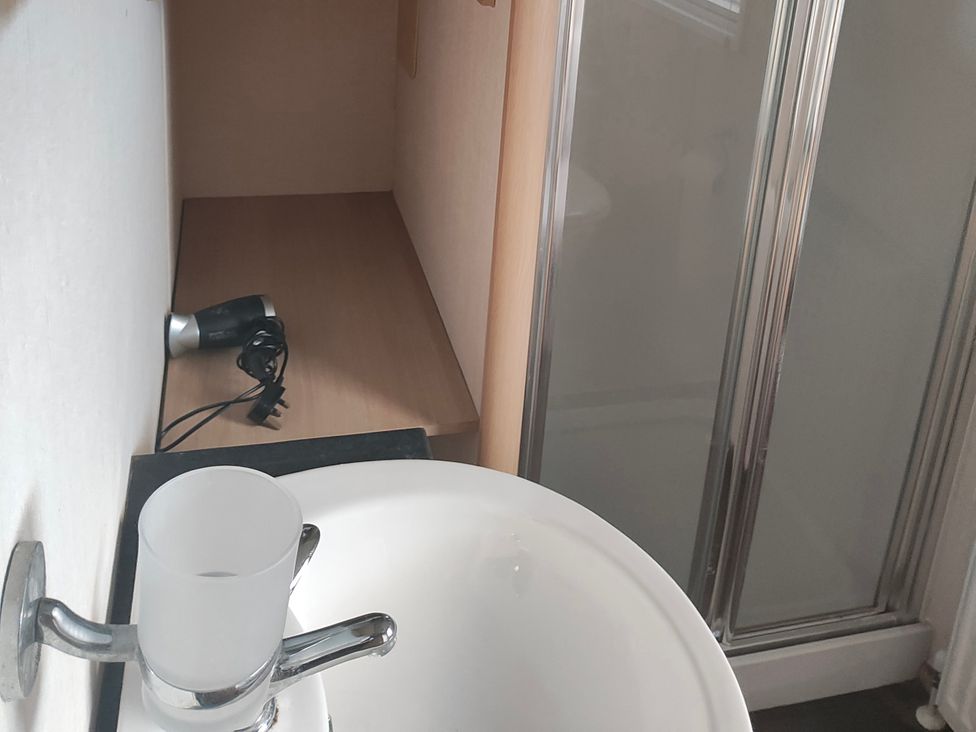 A bathroom with a sink and shower at Sands Retreat in Redcar