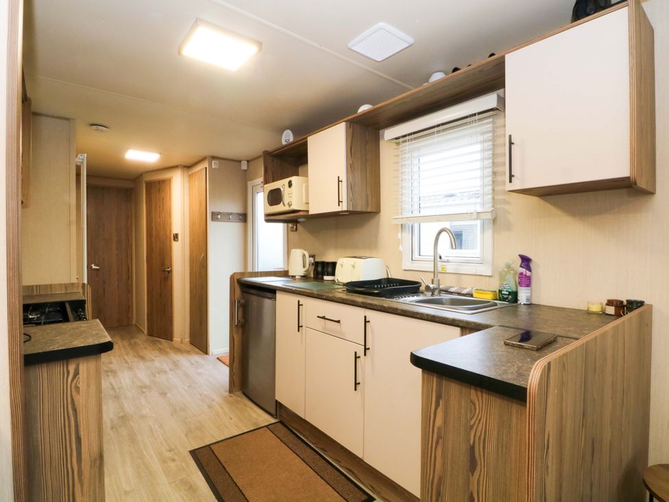 A kitchen with cabinets and appliances at F2 in 
