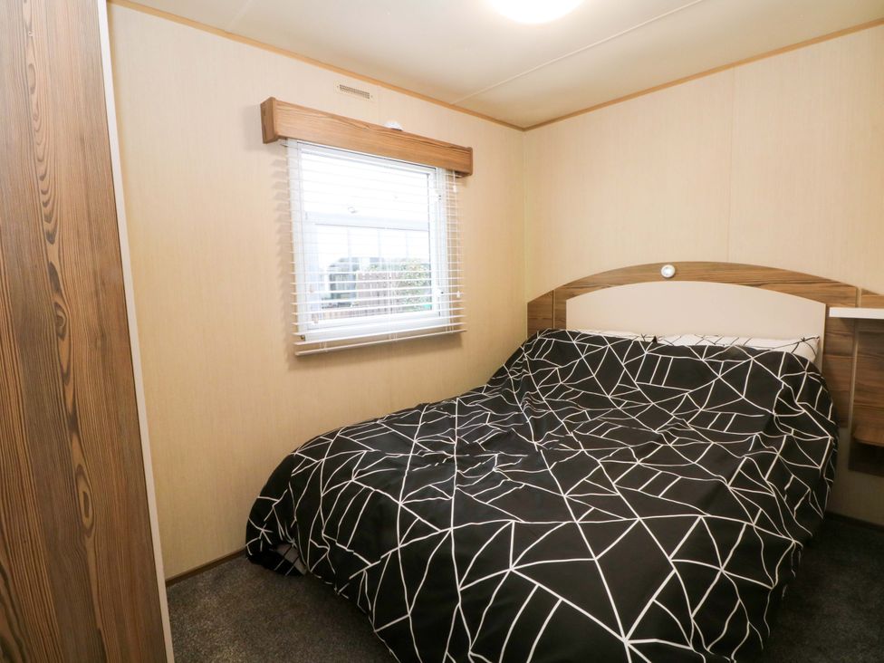 A bedroom with a bed and a window at F2