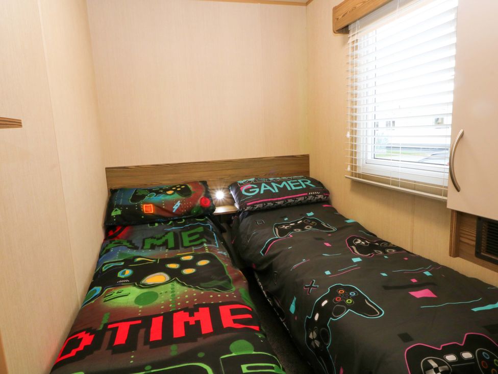 A bedroom with two beds and gaming-themed bedding at F2 
