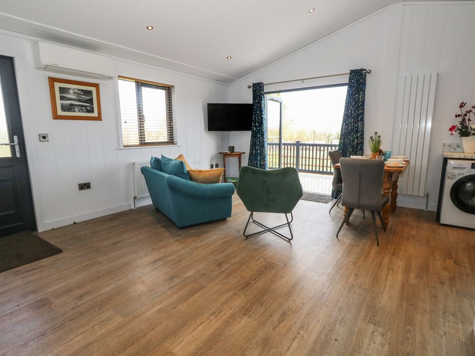 A living room with a sofa and table at Grass Roots
