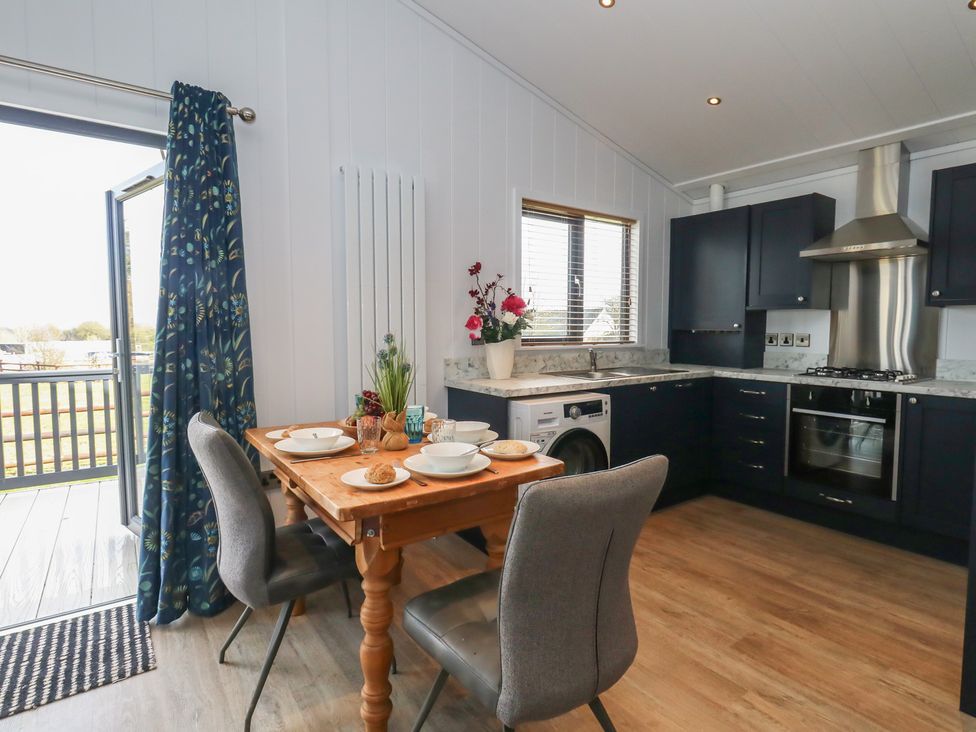 A kitchen with a table and chairs at Grass Roots in 