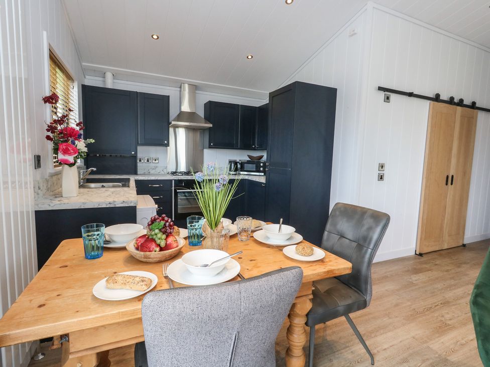 A kitchen with a dining table and chairs at Grass Roots