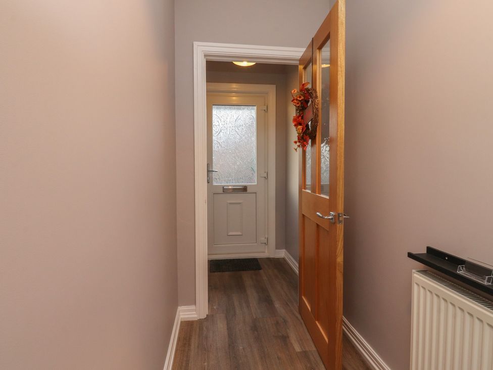A hallway with a door and a welcome mat at Flat 6 in Lytham St. Annes