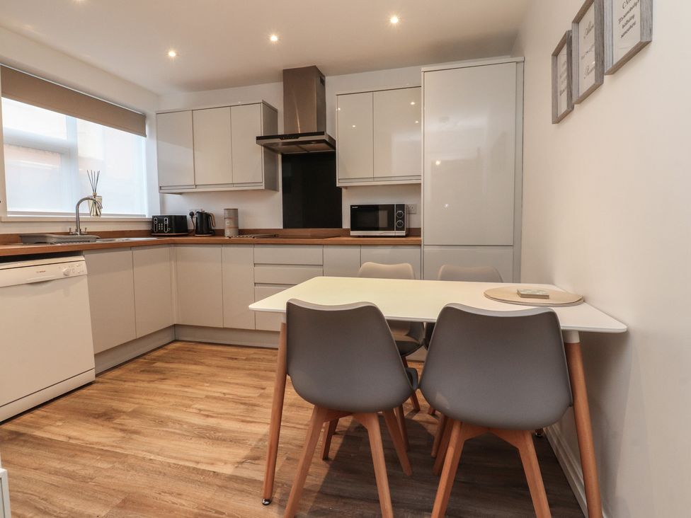 A kitchen with a table and chairs at Flat 6 in Lytham St. Annes