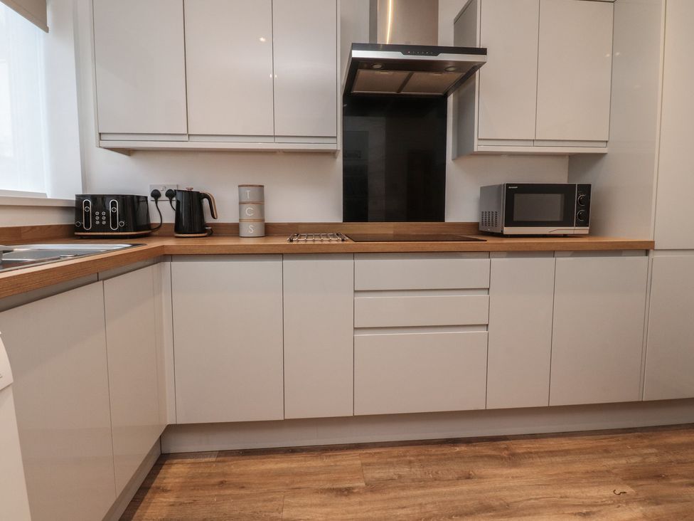 A kitchen with appliances and cabinets at Flat 6 in Lytham St. Annes