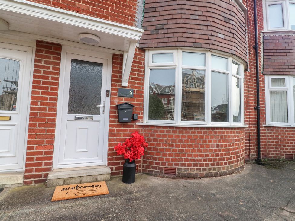 A front entrance with a door, doormat, and flower pot at Seaside Serenity in Lytham St. Annes