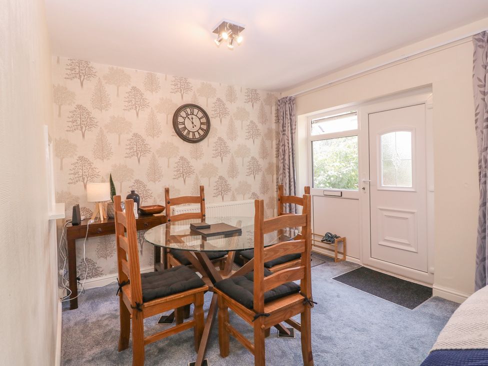 A dining room with a table and chairs at 24 Cefn Court Newport