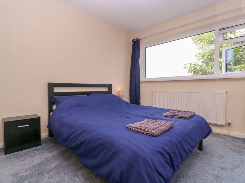 A bedroom with a bed and lamp at 24 Cefn Court Newport