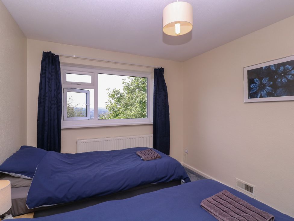 A bedroom with two single beds and a window at 24 Cefn Court in Newport