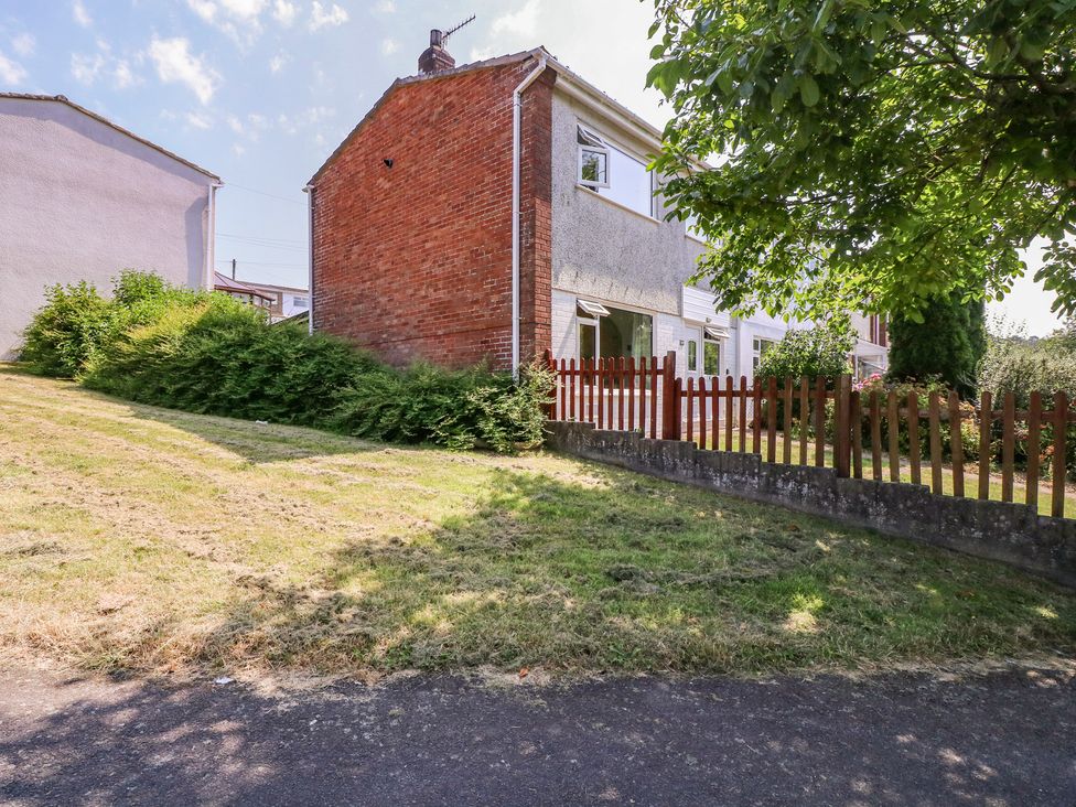 A house with a fence and garden area at 24 Cefn Court Newport