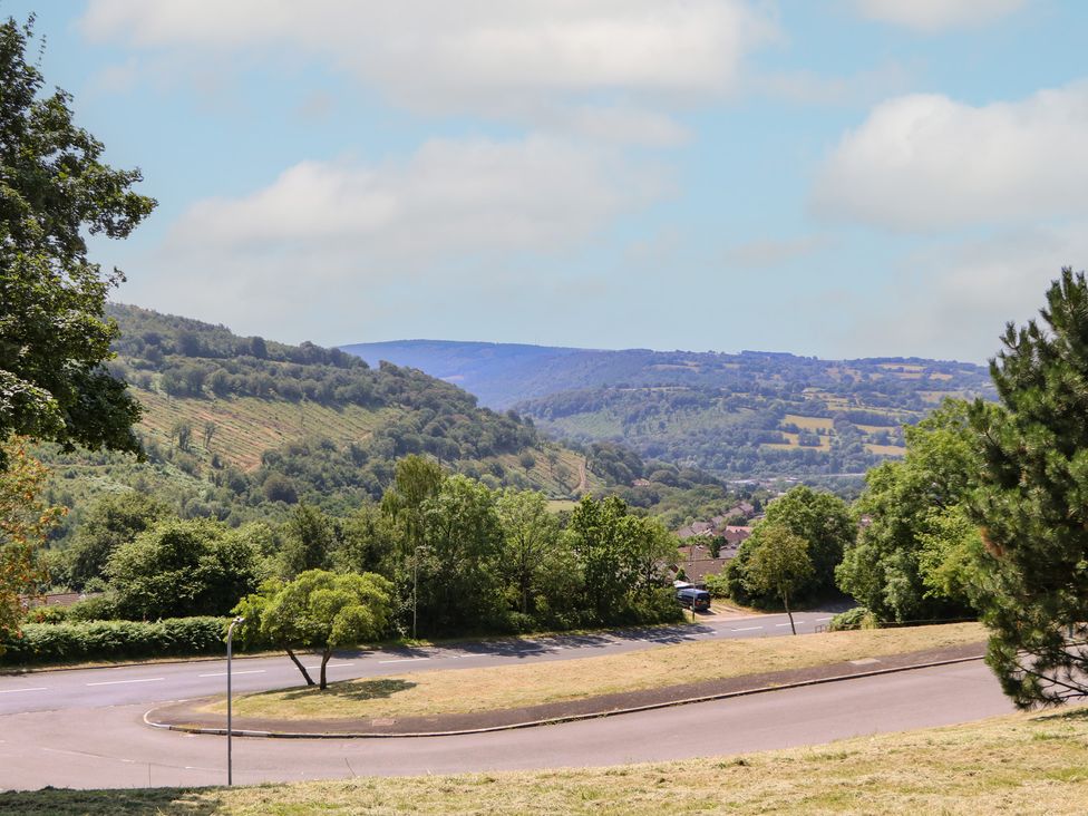 A view of hills and trees along a winding road at 24 Cefn Court in Newport