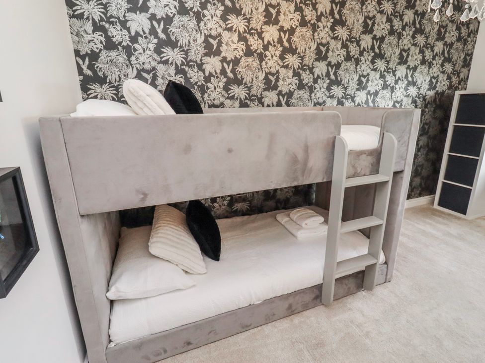 A bunk bed with pillows and sheets at The Joiners Cottage in Birling near Warkworth