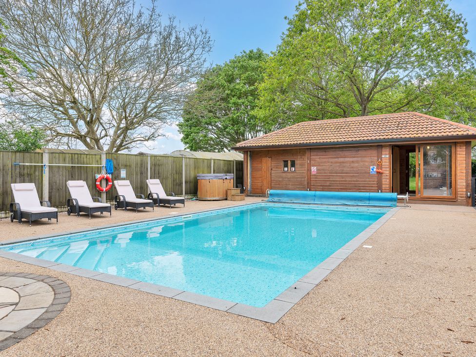 An outdoor area with a swimming pool and lounge chairs at Oldfields