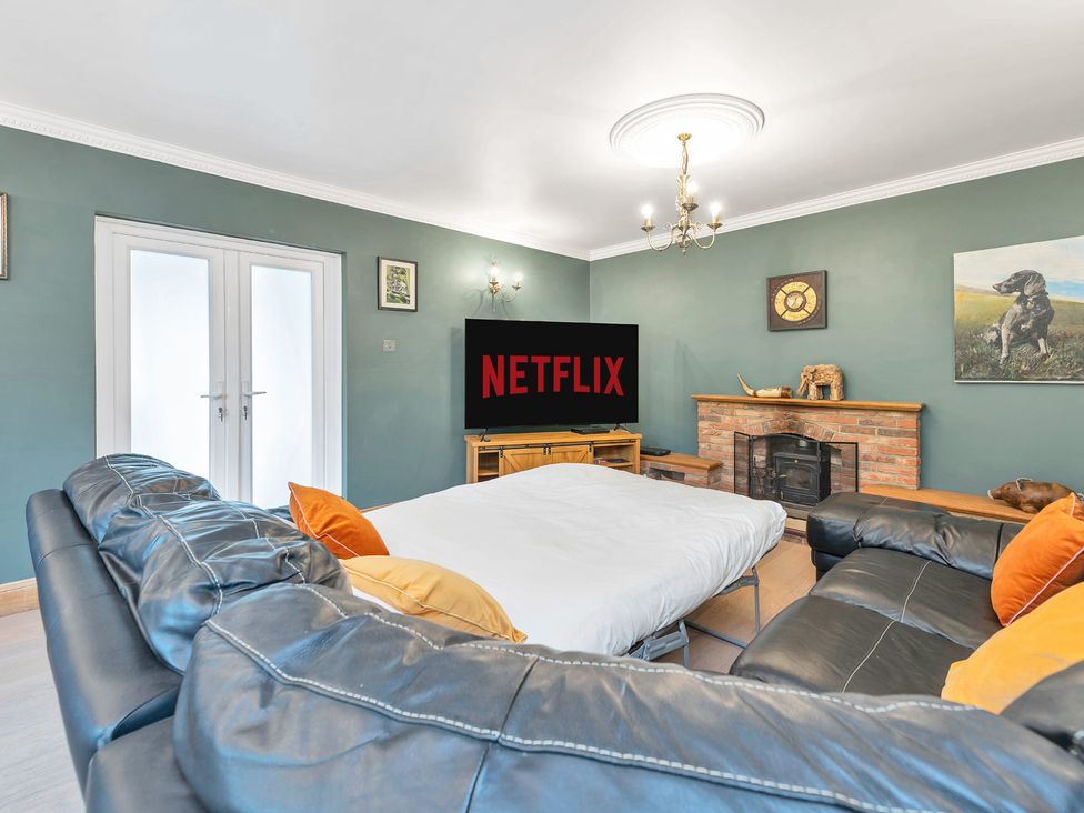A living room with a sofa and television at Oldfields