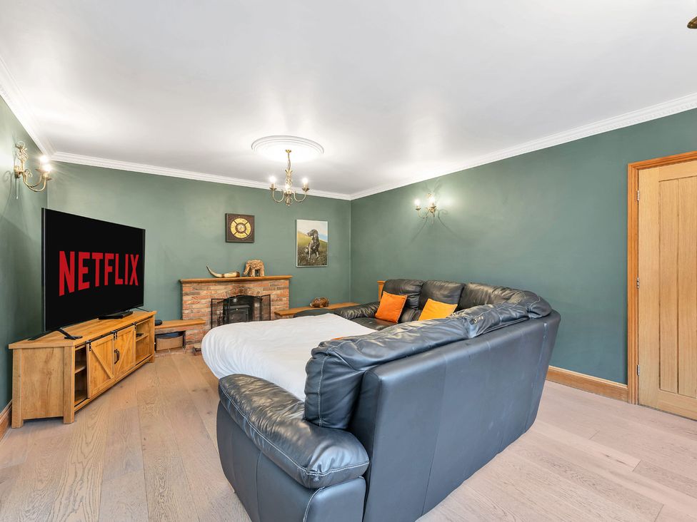 A living room with a sofa and television at Oldfields